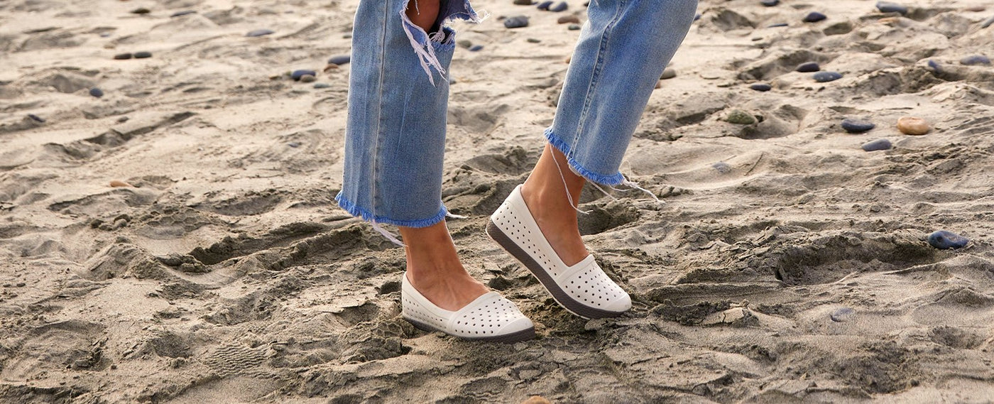 woman standing in sand with joybees espadrille shoes on