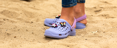 girl standing in sand with joybees clogs on