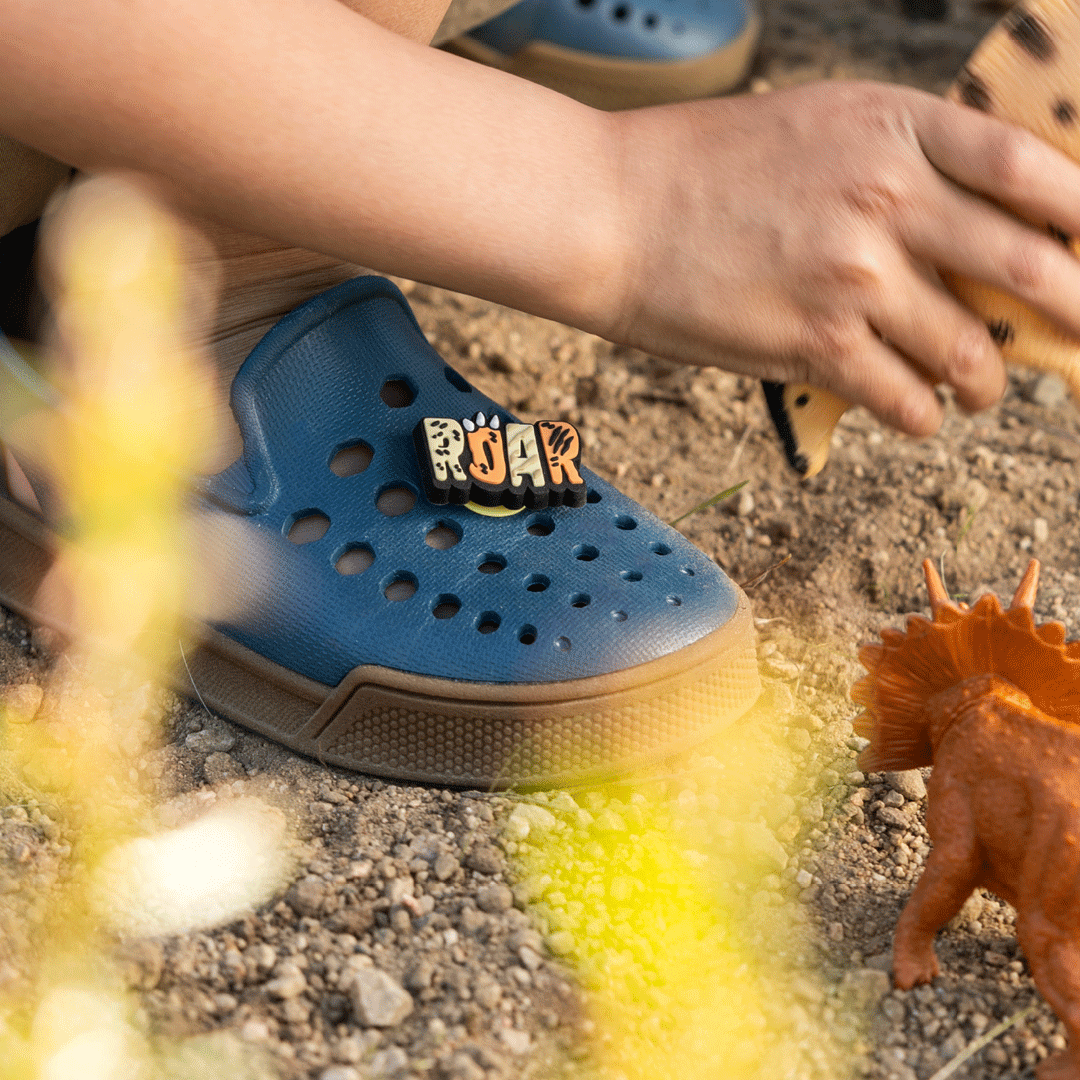 Closeup of Roar Popinz shoe charm in blue skate sneaker